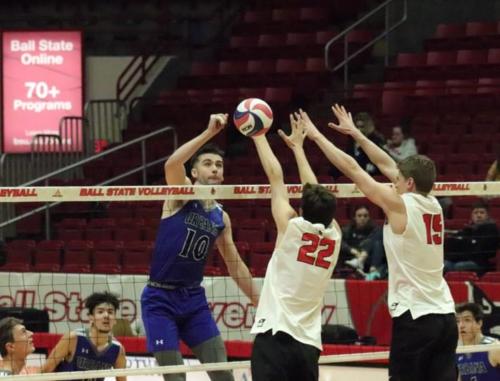 Sophomore Preston Kent, Number 10, hits the ball over the net while Nick Martinski (Left) and Will Heppe (Right) attempt to block the hit at the Ball State vs. Urbana Men’s Volleyball game at Worthen Arena in Muncie, IN on Thursday, Feb. 6, 2020 (Jennifer McGowen). 
